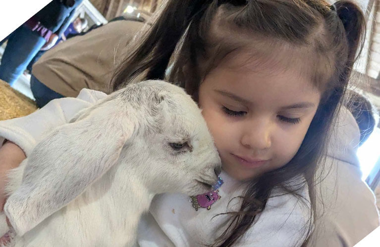 767x500_Spring_GirlCuddlingGoat